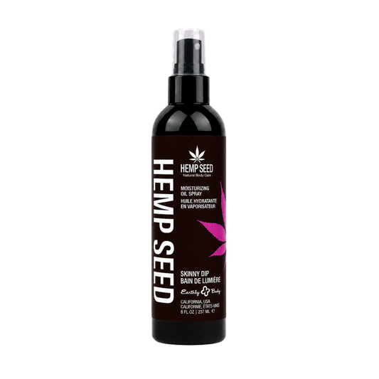 A bottle of Hemp Seed Moisturizing Oil Spray on a plain white background. The bottle is black with a dark brown label featuring white text and a pink leaf graphic.